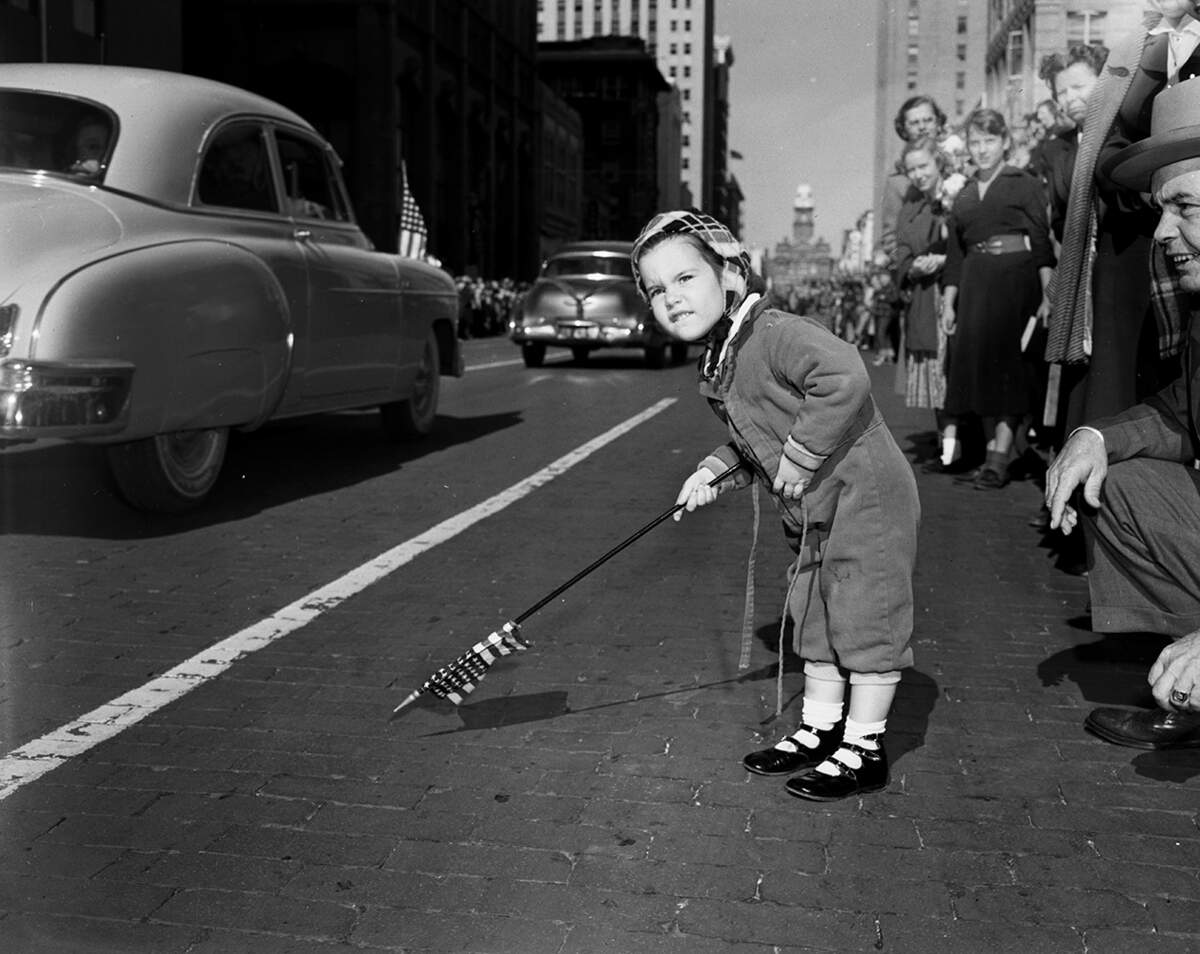 Nov. 11, 1952: Anita Louise Malone, 3, daughter of Mr. and Mrs. A.M. Malone, 313 Colonial, waves her flag as she waits for the downtown Fort Worth Armistice Day parade to pass by.