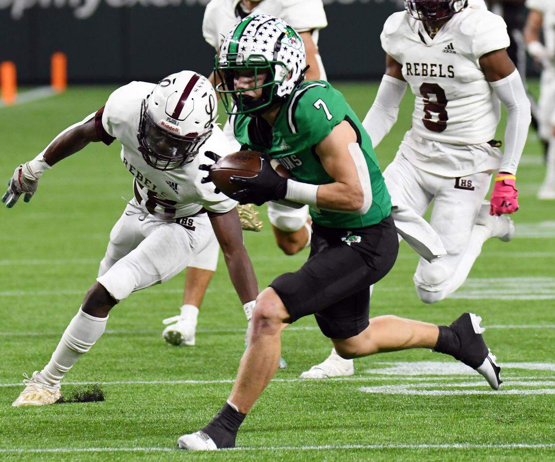 Southlake Carroll’s Jacob Jordan, front, makes the catch and run for a touchdown to take a 13-0 lead behind Midland Legacy’s Damien Johnson, left, and John Washington the first quarter of their Class 6A Division 1 Area football game Saturday, November 20, 2021 at Globe Life Field in Arlington, Texas. Special/Bob Haynes