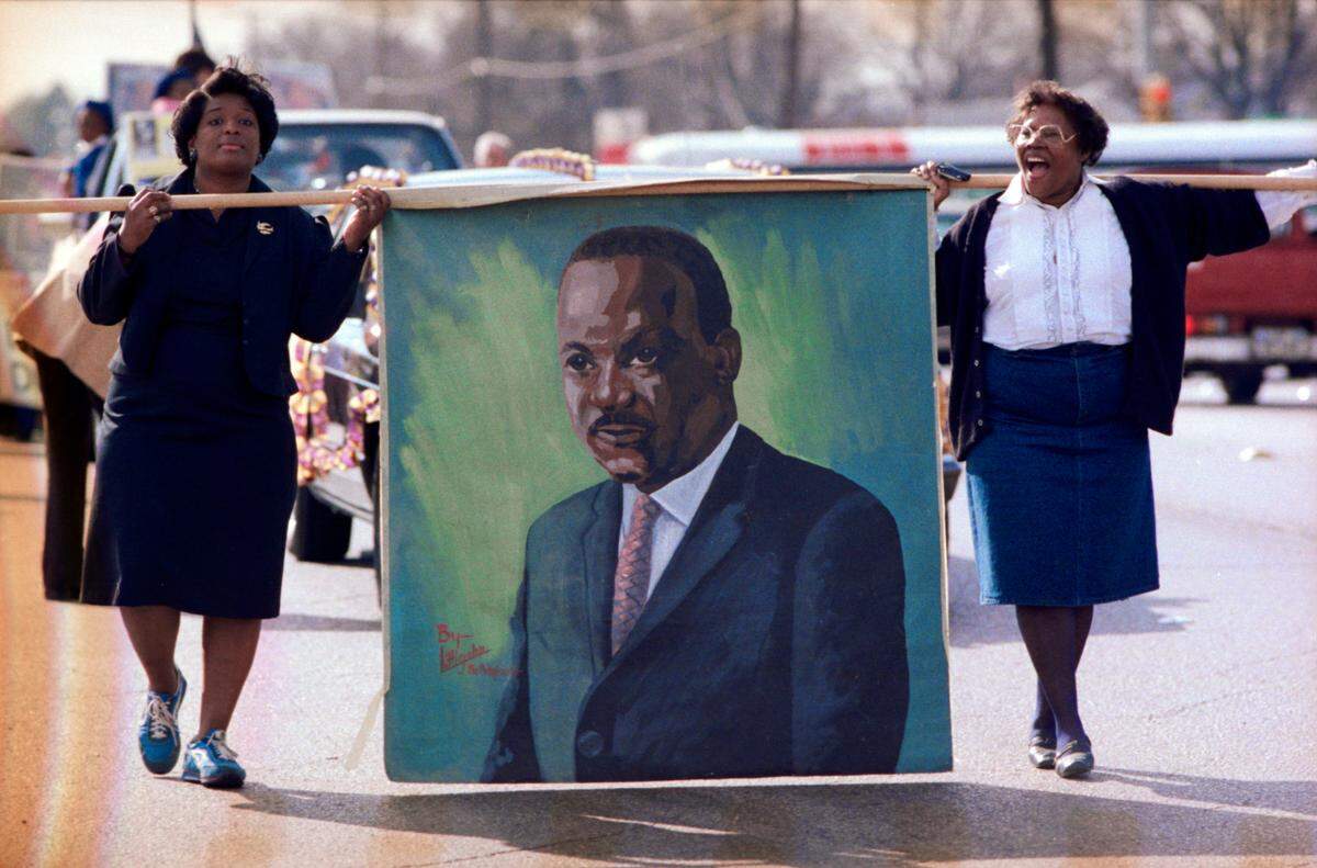 Jan. 15, 1986: Opal Lee, right, and Brenda Polk carry a painted banner of civil rights leader Martin Luther King Jr. during a memorial march along East Rosedale Street in Fort Worth