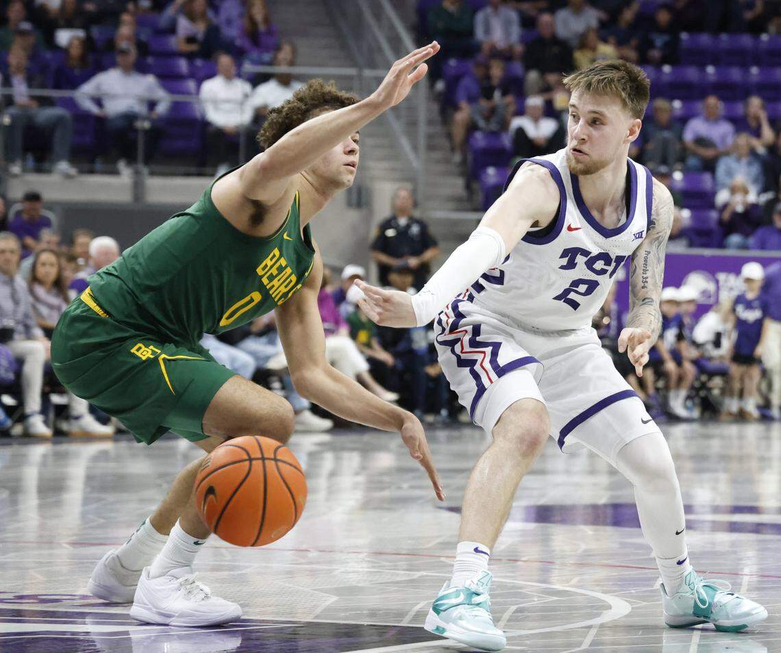 TCU guard Brock Harding (2) passes inside to forward David Punch (15) in front of Baylor guard Dan Skillings Jr. (0) during the second half of a NCAA basketball game between Baylor University and TCU at Schollmaier Arena in Fort Worth, Texas, Saturday Jan. 03, 2026