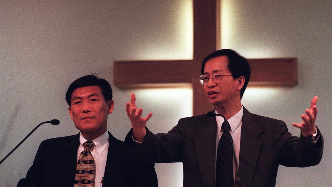 In this 1999 file photo, Rev. Edward Leung, right gives his sermon in Cantonese at Arlington Chinese Church while church member Jeff Hwang, left, translates it into Mandarin.