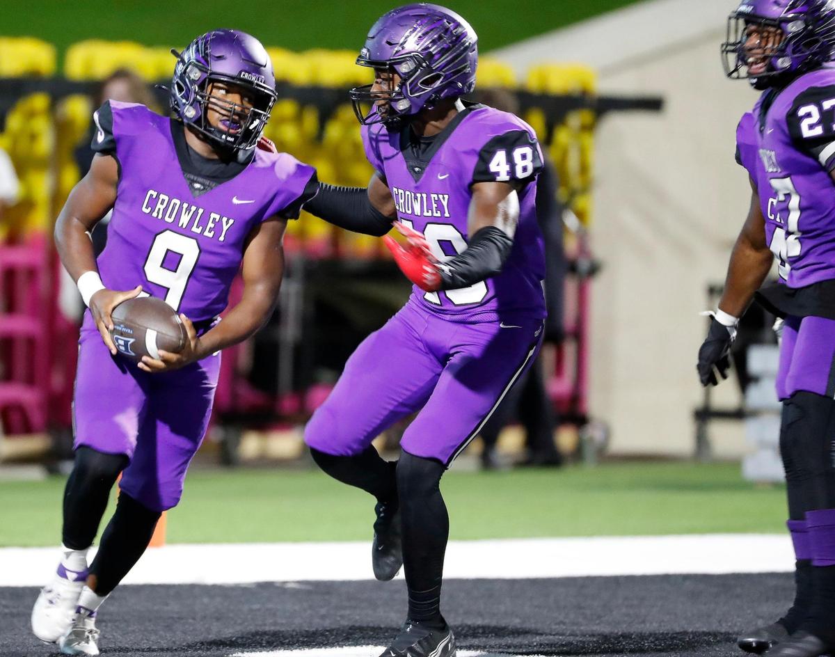Crowley inside linebacker Mekhi Ford (48) congratulates inside linebacker Chris Blake (9) after Blake’s pick six in the first half of a high school football game at Crowley ISD Multipurpose Stadium in Crowley Texas, Friday, Sept. 23, 2022. L.D. Bell led Crowley 14-10 at the half. (Special to the Star-Telegram Bob Booth)