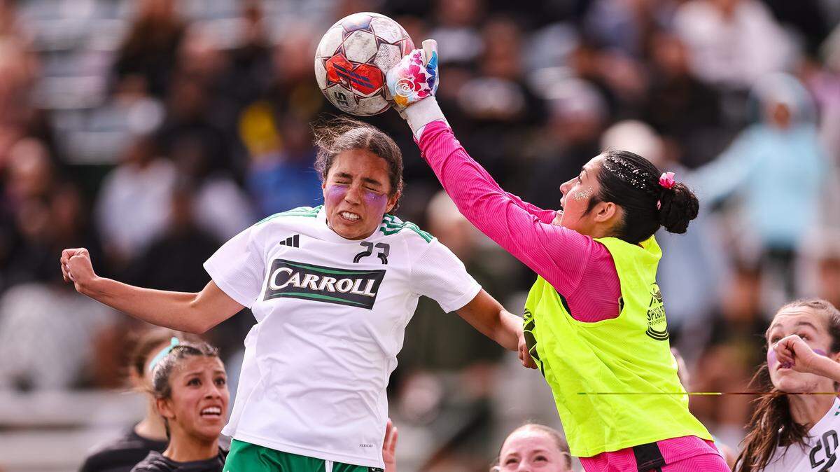 Southlake Carroll striker Mariana Auns attempts to head the ball as the Forney goalkeeper blocks the ball in a Class 6A Division II state semifinal Saturday at Memorial Stadium in Mesquite.