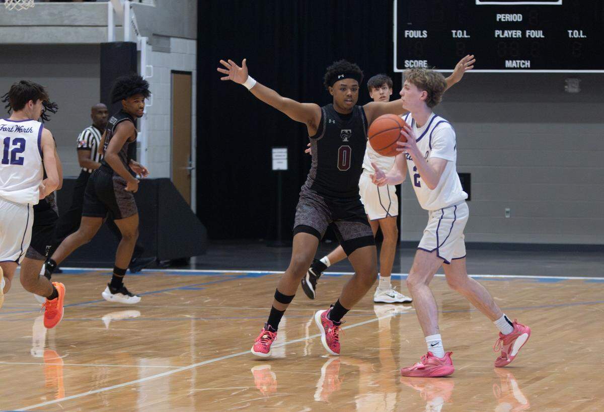 Mansfield Timberview’s Ryan Wright (0) puts pressure on Fort Worth Paschal’s Carson Wessinger (2) in a Class 5A Division 1 bi-district game on Tuesday, February 18, 2025 at the Arlington ISD Athletics Center in Arlington, Texas. Timberview defeated Paschal 62-39.