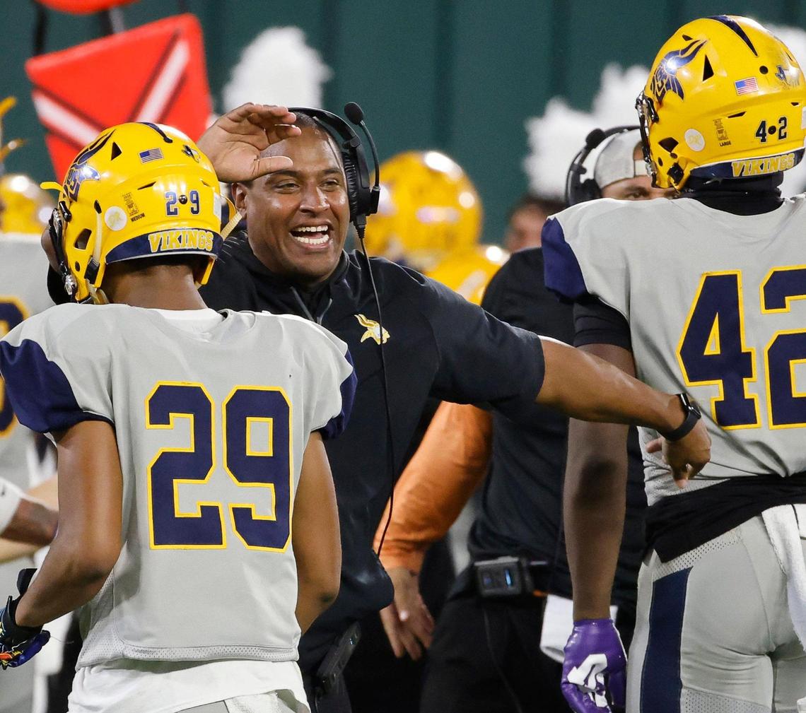 Arlington Lamar head coach Billy Skinner celebrates a turnover as his defense leaves the field in the first half of a UIL high school football game on Thursday, October 26, 2023 at Choctaw Stadium in Arlington, Texas.