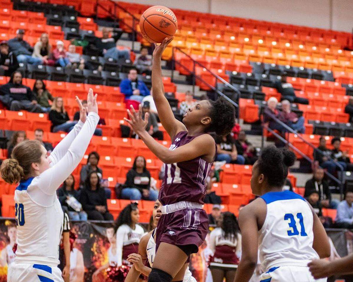 Timberview’s Kennedy Wilson scores past Boswell’s Jamie Garcia (left) and Laylah Davis in a regional quarterfinal game, Monday Feb. 18, 2019 from Aledo HS. Timberview won 68-46.