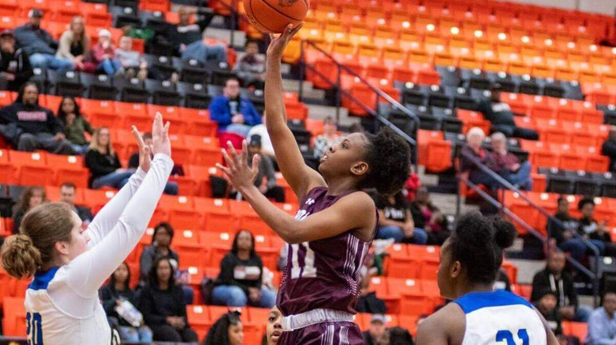 Timberview’s Kennedy Wilson scores past Boswell’s Jamie Garcia (left) and Laylah Davis in a regional quarterfinal game, Monday Feb. 18, 2019 from Aledo HS. Timberview won 68-46.
