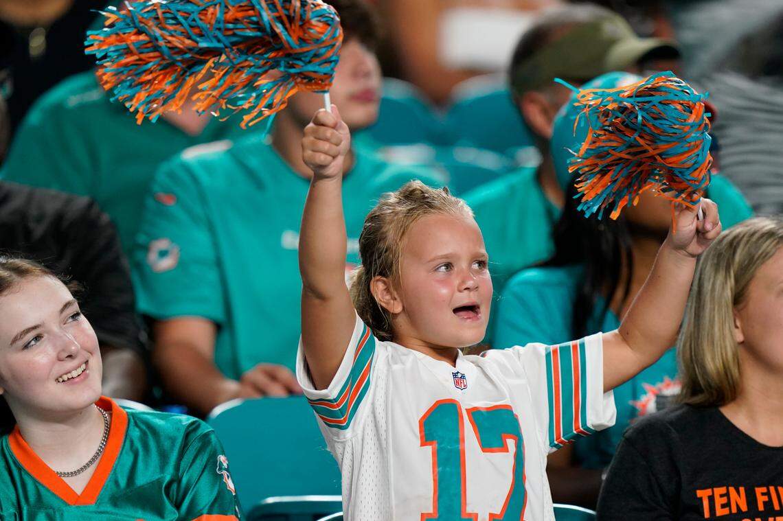 Miami Dolphins fans cheer the team during the second half of a NFL preseason football game against the Atlanta Falcons, Saturday, Aug. 21, 2021, in Miami Gardens, Fla. (AP Photo/Wilfredo Lee)