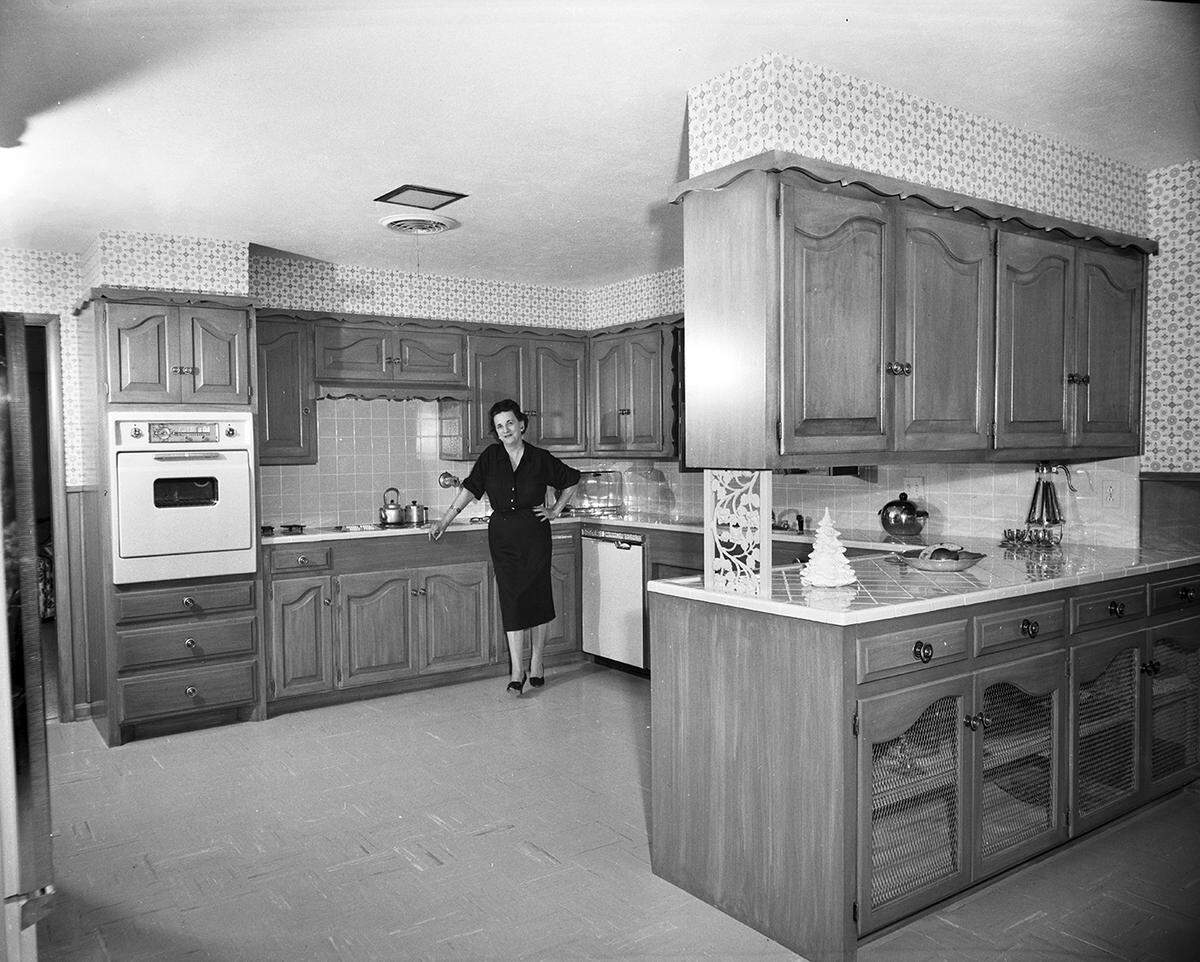 Dec. 17, 1958: “Fruitwood Finish: Mrs. W. W. Martin is shown in the charming kitchen of her new home in Westcliff. Cabinets are finished in fruitwood.”