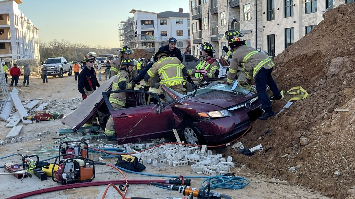 Scaffolding that collapsed at a Mansfield construction site crushed a vehicle and injured at least two people Thursday morning.