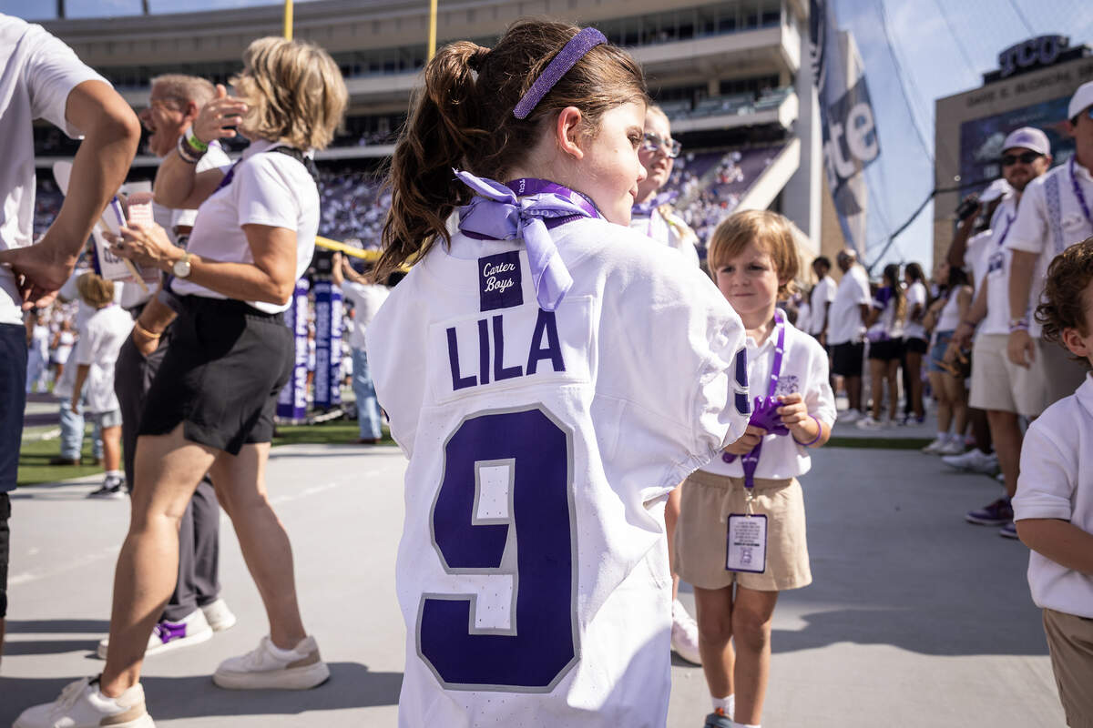 Scarlett Bonner, 6, wears a TCU football jersey with her late sister’s name on the back before the Horned Frogs’ game against SMU on Saturday at Amon G. Carter Stadium. Bonner’s sister Lila was killed in the catastrophic floods at Camp Mystic in Central Texas.