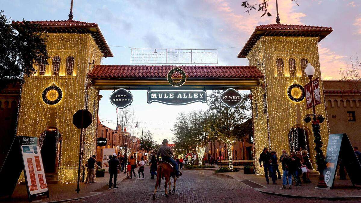 Ricky Hess rides Nellie onto Mule Alley in the Fort Worth Stockyards on a Friday night, December 10, 2021.