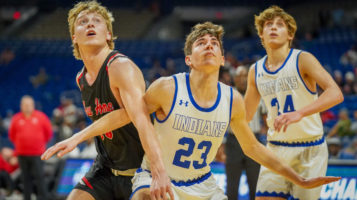 Lipan’s Alberto Andreatta (23) blocks out New Home’s Caleb Cook (left) as Court Gaylor (34) looks on in a Class 2A state semifinal on Friday, March 8, 2024 at the Alamodome in San Antonio, Texas. Lipan defeated New home 40-39 in overtime.