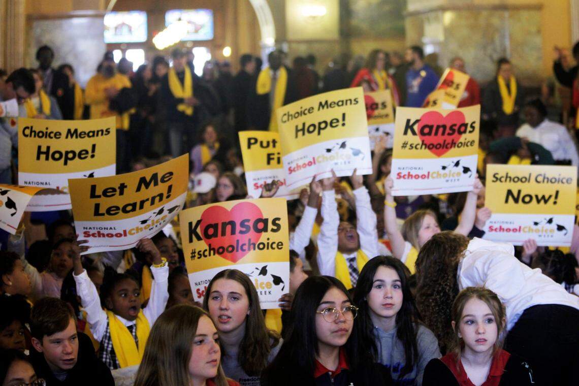 Private and home school students, their parents and advocates crowed part of the second floor of the Kansas Statehouse for a rally for giving parents tax dollars earmarked for public schools and allowing them to spend it how they choose on education, Wednesday, Jan. 25, 2023, in Topeka, Kan.. Years of pandemic restrictions and curriculum battles have emboldened a push from Republican lawmakers and school choice advocates to funnel public funds to private and religious schools in at least a dozen statehouses. (AP Photo/John Hanna)