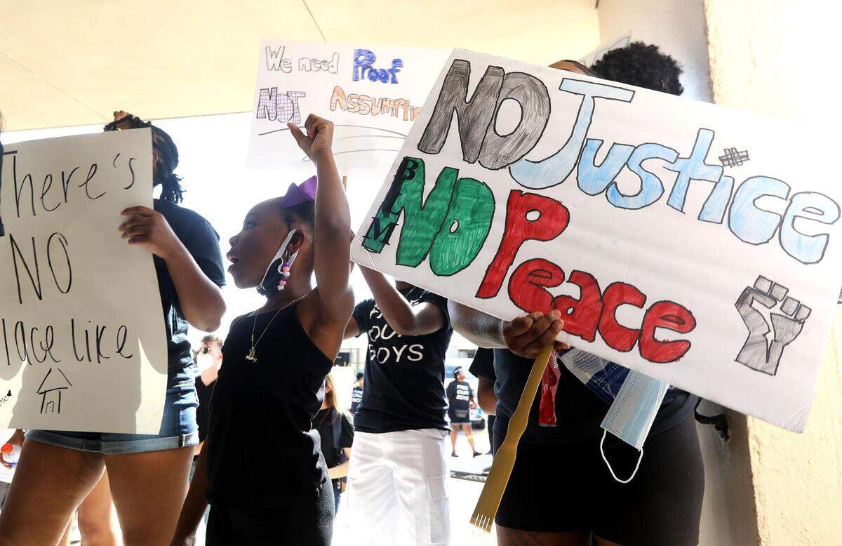 Members of Enough is Enough and family members gather at the Tarrant County Juvenile Detention Center on Friday, June 26, 2020, to protest the detainment of multiple youth accused of involvement in a park shooting on Mother's Day.