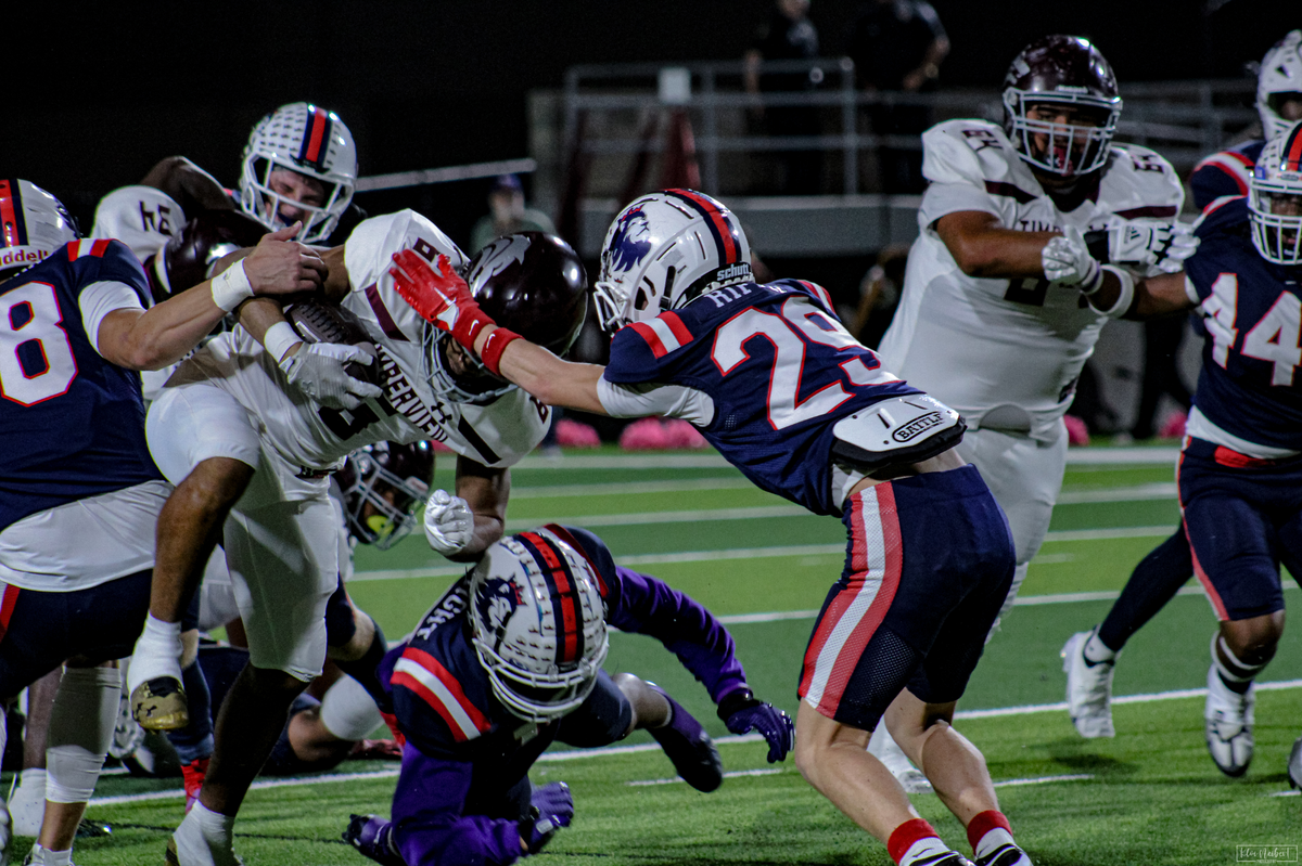 Richland defensive back Brayden Riffle (29) and a host of Royals defenders try to bring down Mansfield Timberview running back Jaylon Woods (6) on Friday, October 27, 2023 at Birdville Fine Arts/Athletics Complex in North Richland Hills, Texas.