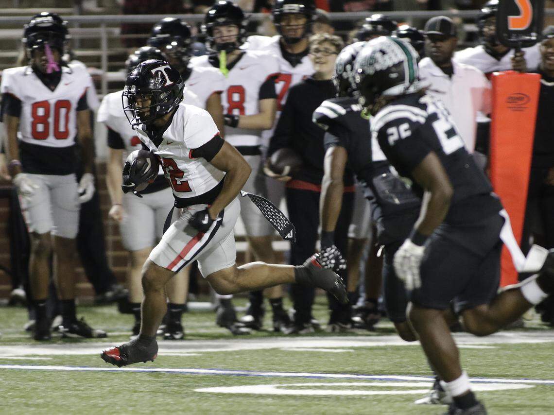 Euless Trinity running back Jayden Hollins (22) finds running room on the sideline for Trinity’s first touchdown against Mansfield Lake Ridge during their Class 6A Division I bi-district game on Friday, November 14, 2025 at Newsom Stadium in Mansfield Texas.