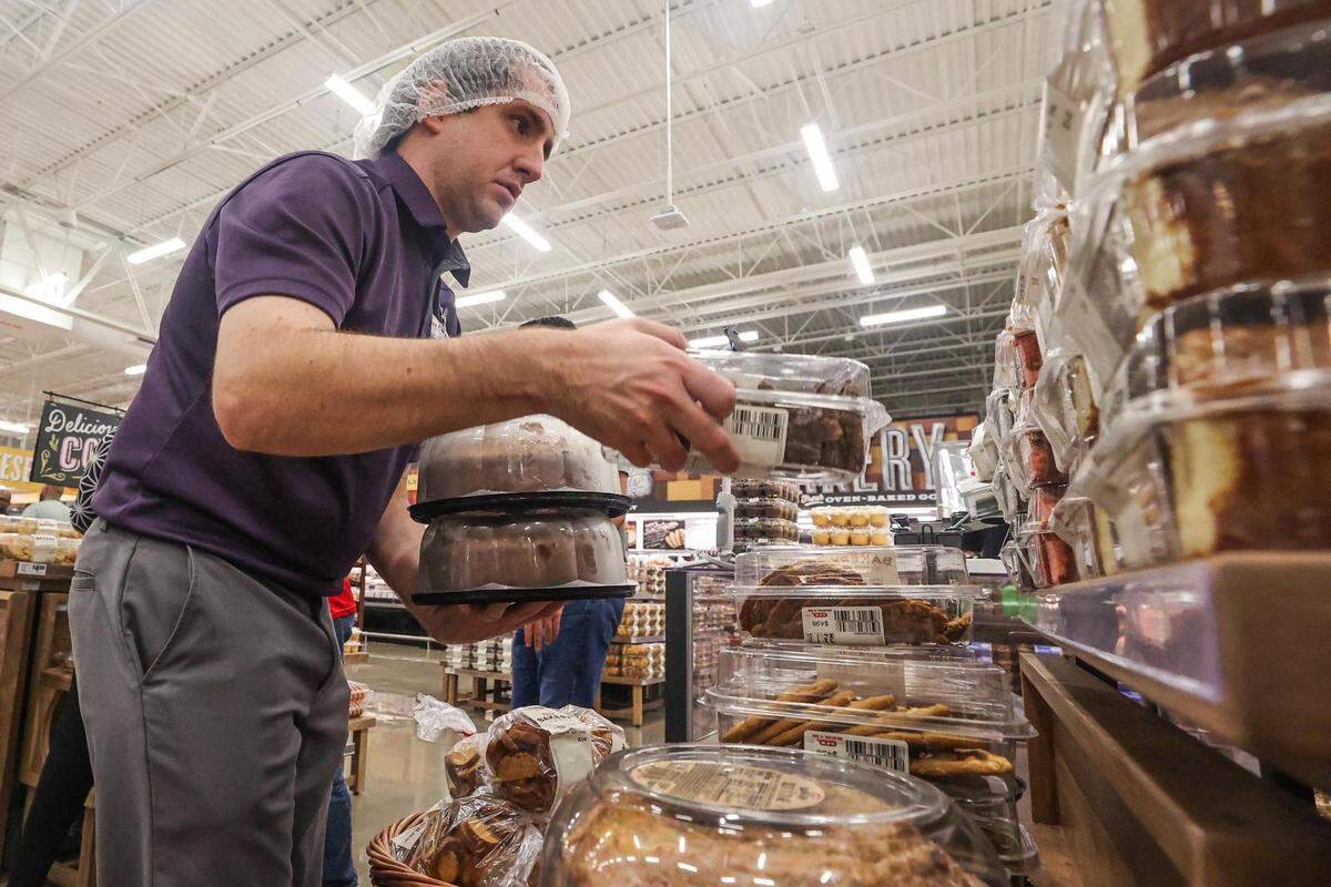 Bakery Manager Kolby Franklin puts price tags on the package baked goods to prepare for the grand opening of the new H-E-B location opening in McKinney, Texas on Tuesday, July 18, 2023.