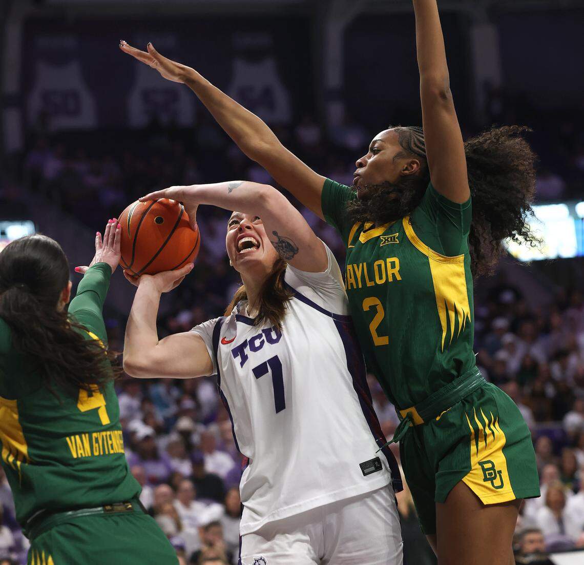 TCU forward Marta Suarez (7) is defended by Baylor guard Jana Van Gytenbeek (4) and forward Kiersten Johnson while driving toward the basket Sunday at Schollmaier Arena.