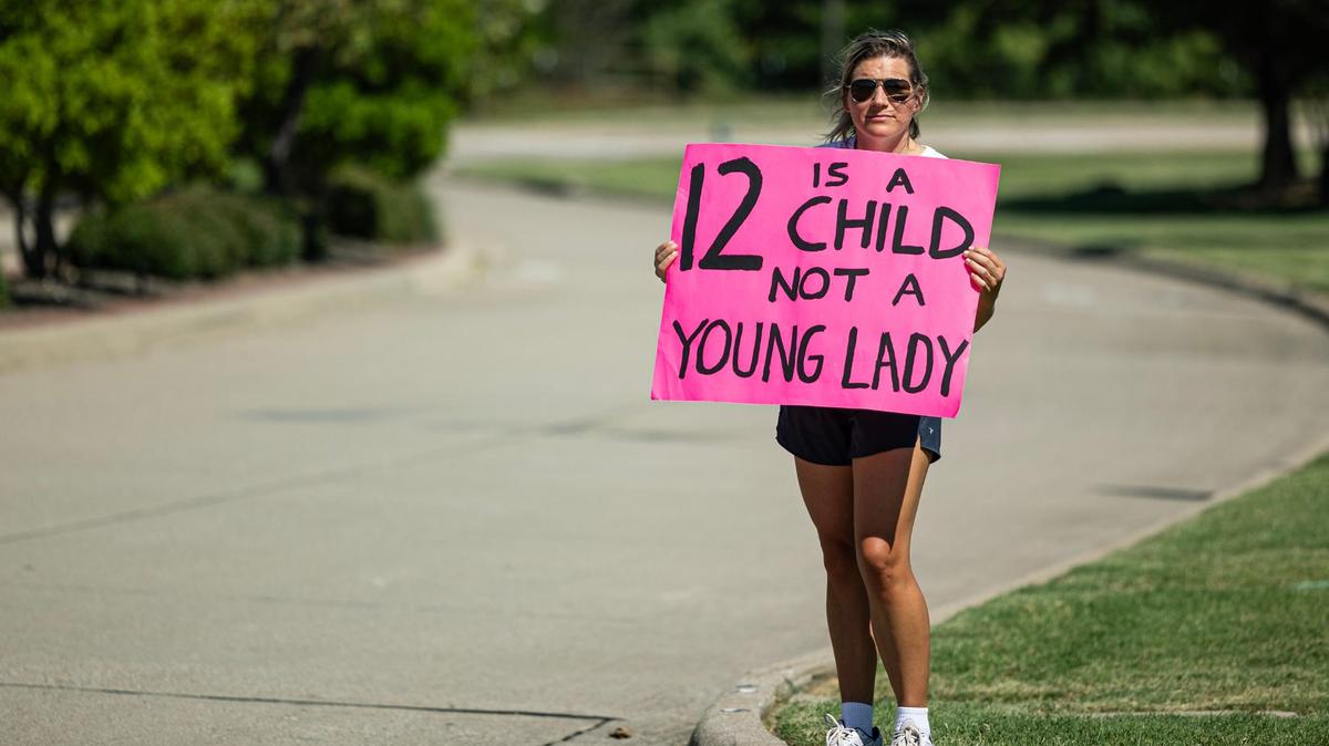 Megan Thompson holds a sign in protest of child and sexual abuse in the church outside of Gateway Church in Southlake on June 22, 2024.