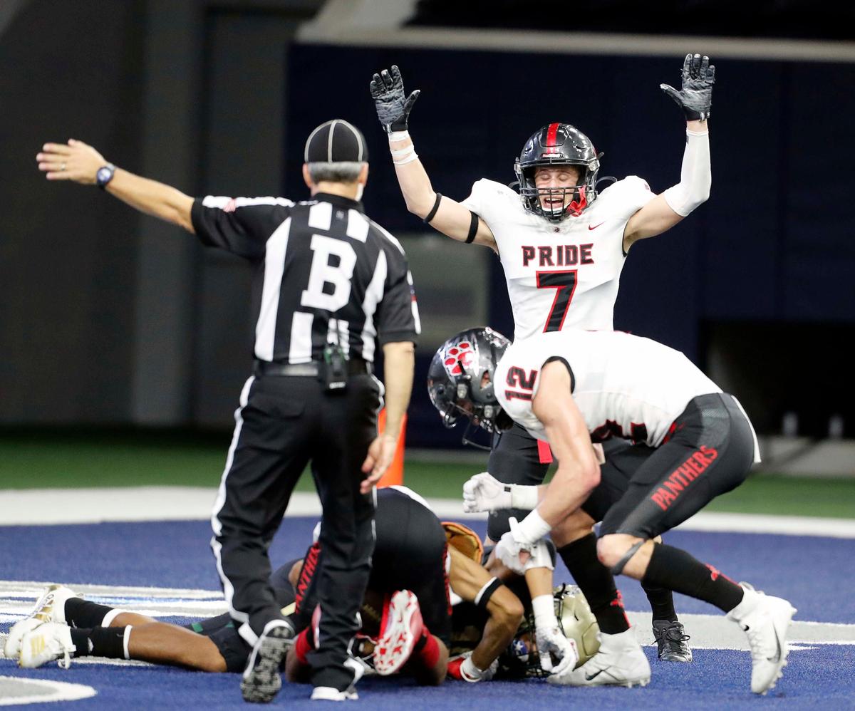 The back judge signals an interception by corner back Dylahn McKinney (16) in the end zone to seal the game for Colleyville as Colleyville Heritage safety Luke Mabe (7) celebrates in the fourth quarter of the 5A Division I Regional Round high school football playoff game at The Star in Frisco, Texas, Saturday, Nov. 30, 2019. Colleyville Heritage defeated BIrdville 24-17. (Special to the Star-Telegram Bob Booth)