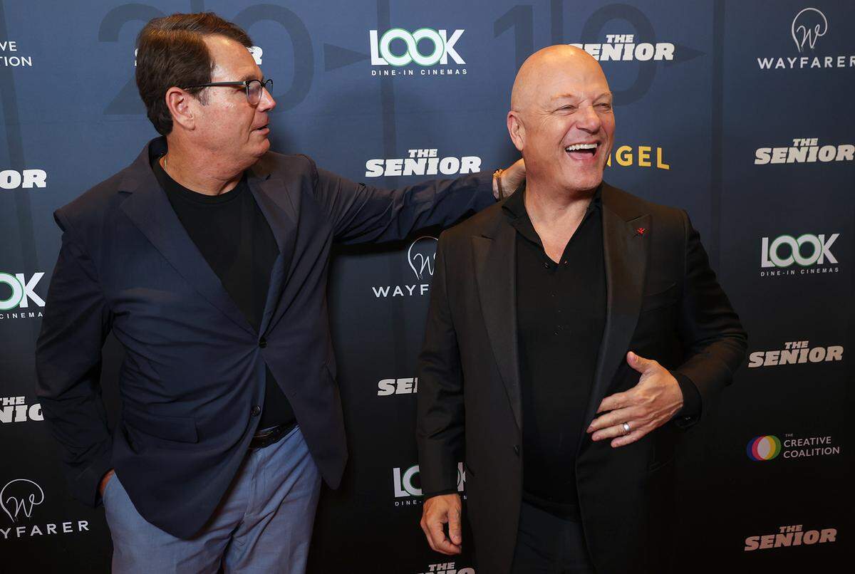Producer Campbell McInnes, left, fixes the collar of “The Senior” lead actor Michael Chiklis during the premiere of the movie on Monday, Sept. 8, 2025, at LOOK Dine-In Cinemas in Bedford.