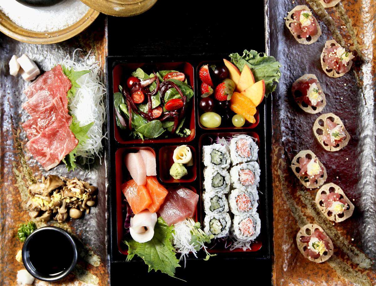 From left to right: The Ishiyaki (beef sashimi seared on a hot river stone), healthy bento box and the Hokkaido scallops and tuna tartare at Shinjuku Station, August 3, 2011.