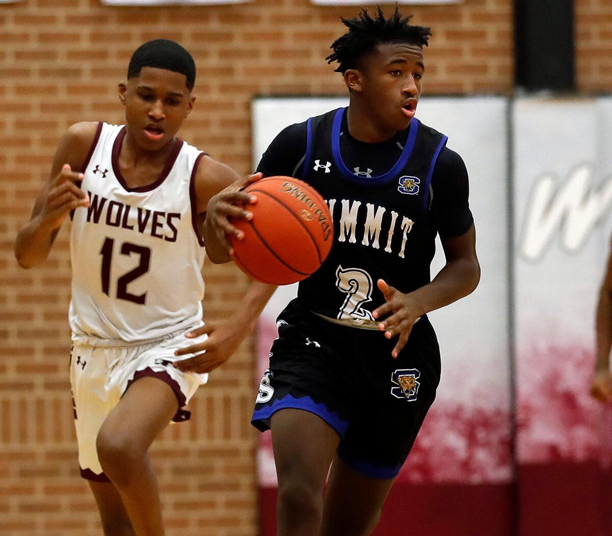 Summit guard Jeffrey Scott (2) brings the ball down court chased by Timberview guard Daniel Viera-Tuck (12) during a high school basketball game at Timberview High School in Arlington, Texas, Tuesday, Jan. 05, 2021. Summit Jaguars defeated the Timberview Wolves 64-62. (Special to the Star-Telegram Bob Booth)
