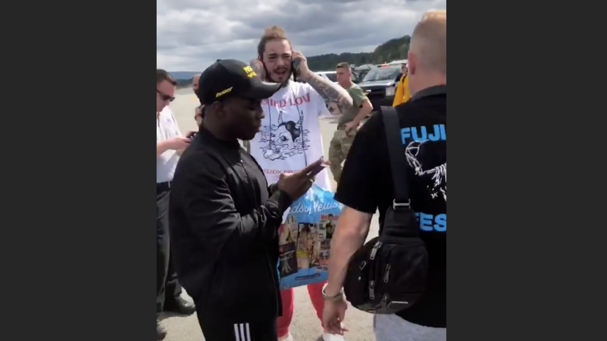 A private plane carrying Grapevine, Texas, rapper Post Malone, center, landed safely just before 2 p.m. at an airport in Orange County, New York, according to reports.