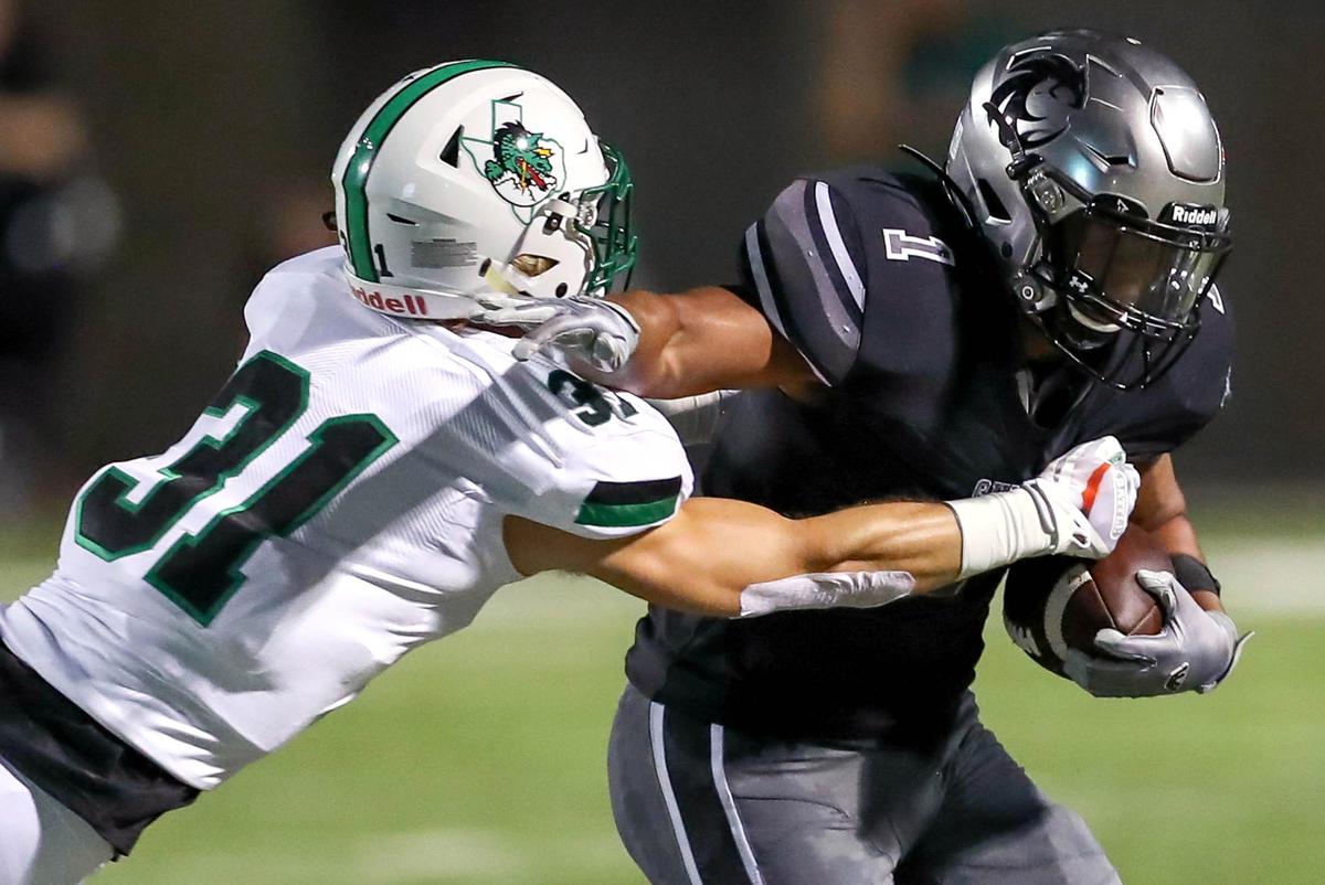 Denton Guyer running back Kaedric Cobbs (1) tries to avoid Southlake Carroll defensive back Jonah Diddridge (31) during the first half, Friday night, October 4, 2019 played at C.H. Collins Complex Stadium in Denton, TX.