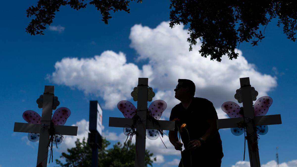 Matthew Solano leaves sunflowers at a memorial to honor the victims killed in last week’s elementary school shooting in Uvalde, Texas, Wednesday, June 1, 2022. On May 24, 2022, an 18-year-old entered the school and fatally shot several children and teachers.