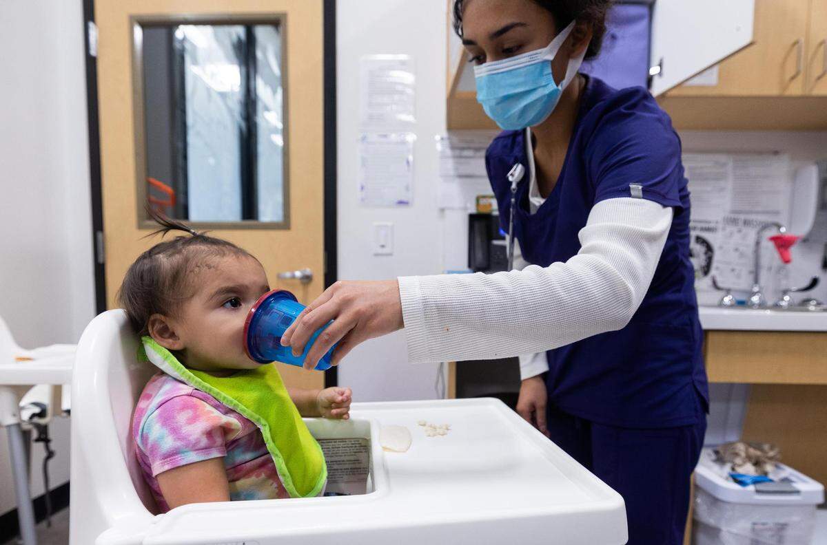 Maria Garcia gives Riley Rodriguez, 1, a bottle at Annie’s Place in October.