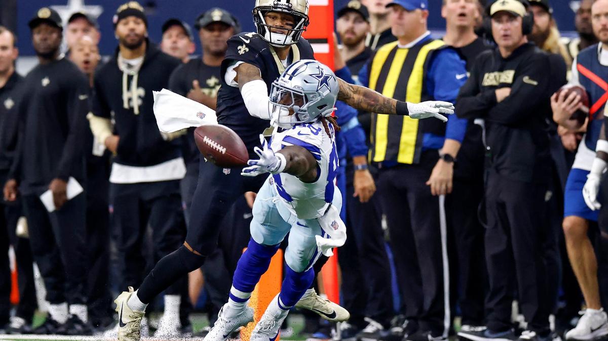 Dallas Cowboys wide receiver CeeDee Lamb reaches for the ball while defended by New Orleans Saints cornerback Alontae Taylor on Sunday.