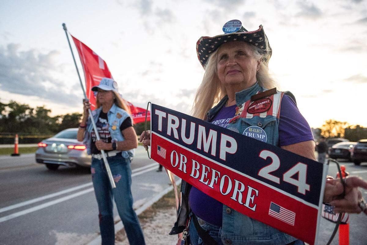 Kathy Clark of Lantana, Florida, holds a sign expressing support for former President Donald Trump in March.