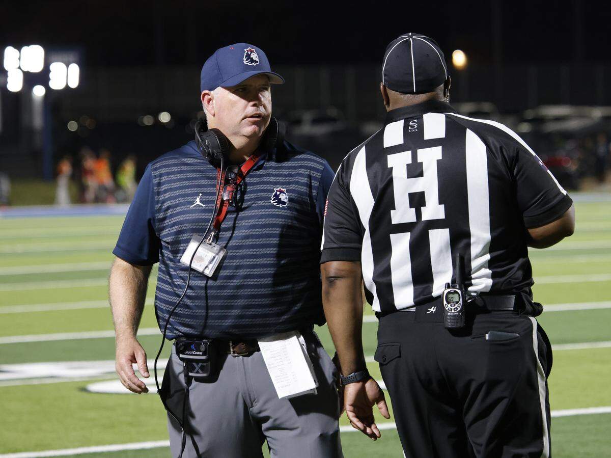 Richland head coach Ged Kates talks with the head linesman during the second half of a football game against Haltom at Birdville FAAC in North Richland Hills, Texas, Friday, Aug. 29, 2025.