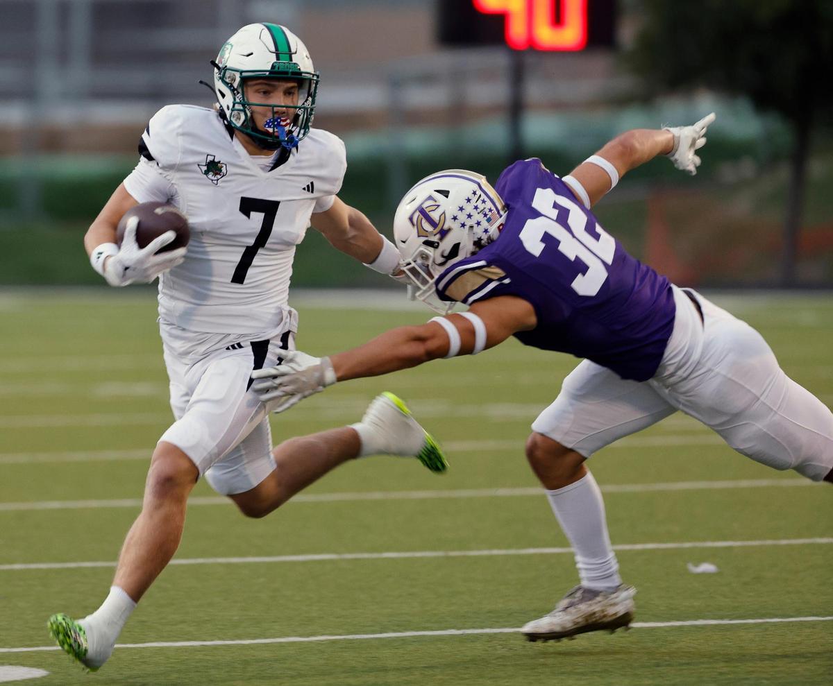 Carroll wide receiver Jacob Jordan (7) avoids the grab from Timber Creek linebacker Luke Gustafson (32) in the first half of a UIL high school football game at Keller ISD Stadium in Keller, Texas, Thursday, Sept. 14, 2023.