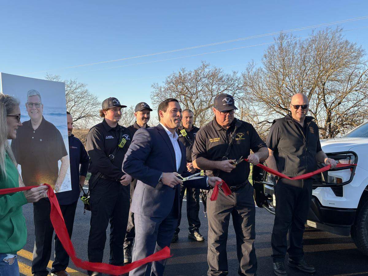Commissioner Manny Ramirez cut the ribbon on Shelton Ranch Road as the sun came up Dec. 18, 2025. Residents of the Vista Ridge neighborhood on Tinsley Lane have been halted for hours at a time because of the trains blocking the one entrance to their community.
