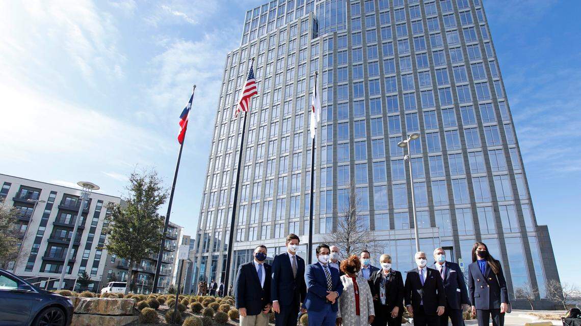 Former Fort Worth Mayor Betsy Price, city council members and other dignitaries pose in front of the city’s future city hall in 2021, when the city announced it purchased the previous Pier 1 building for their new city hall.