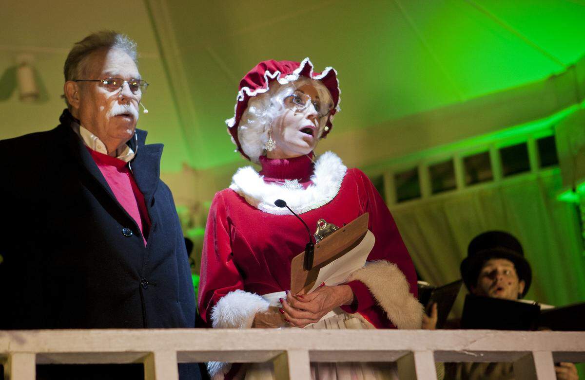 Mayor William D. Tate and Mrs. Claus sing carols on November 24, 2014, at the Town Square Gazebo on Main Street. 