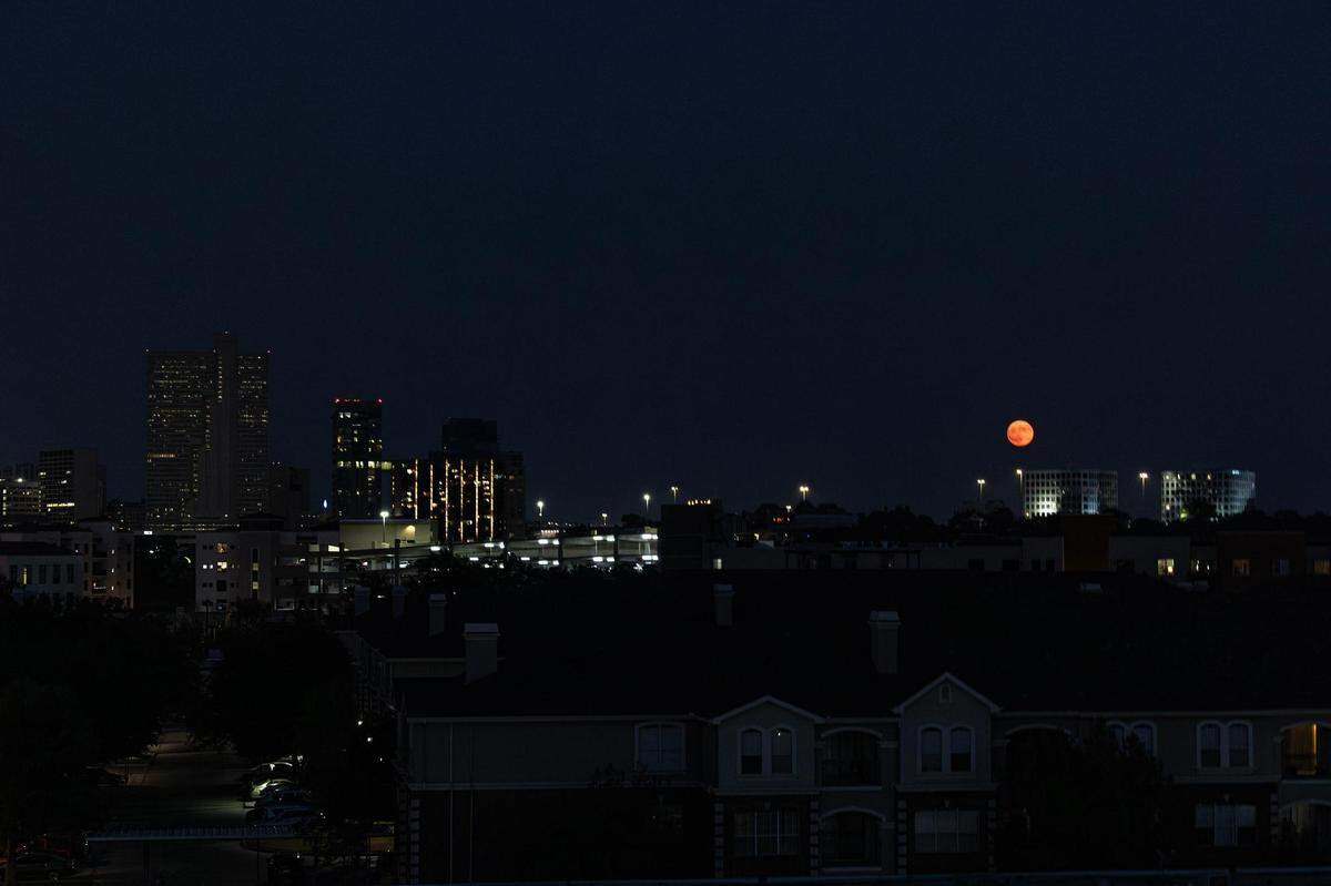 The Super Blue Moon rises over the Summit Office Park Plaza near downtown Fort Worth on Wednesday, Aug. 30, 2023.