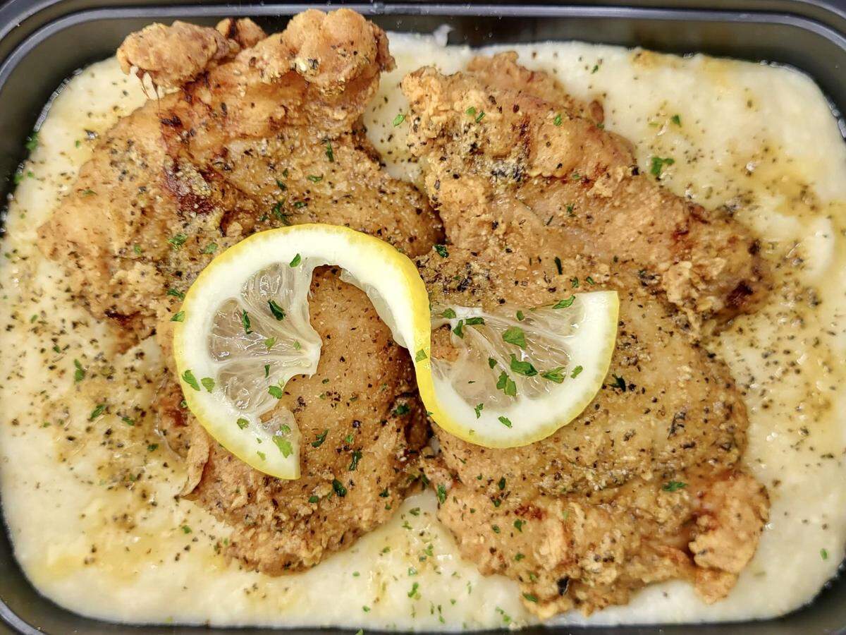 Lemon-pepper chicken and grits at Spice and Gravy Southern Eatery.