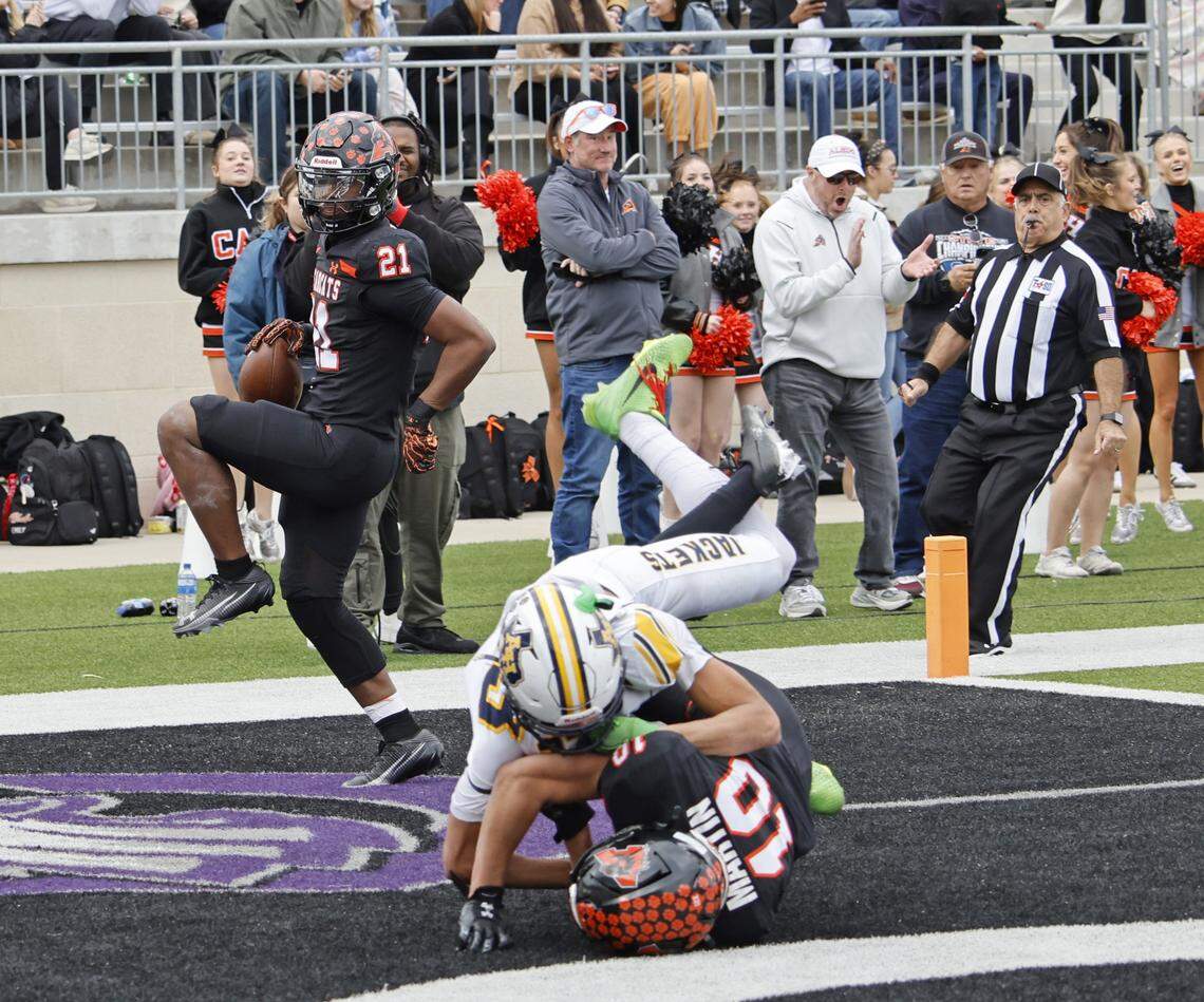 Aledo running back Kaden Winkfield (21) high steps into the end zone against Fort Worth Arlington Heights during the first half of a UIL Class 5A Division I Regional on Friday Nov. 28, 2025 at Crowley ISD Multi-Purpose Stadium in Fort Worth, Texas.