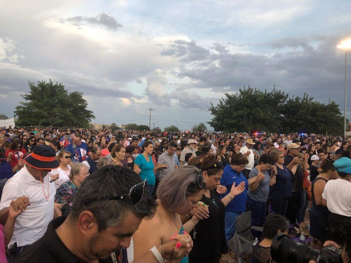 Mourners gather at a vigil for the victims of Saturday’s mass shooting in El Paso.