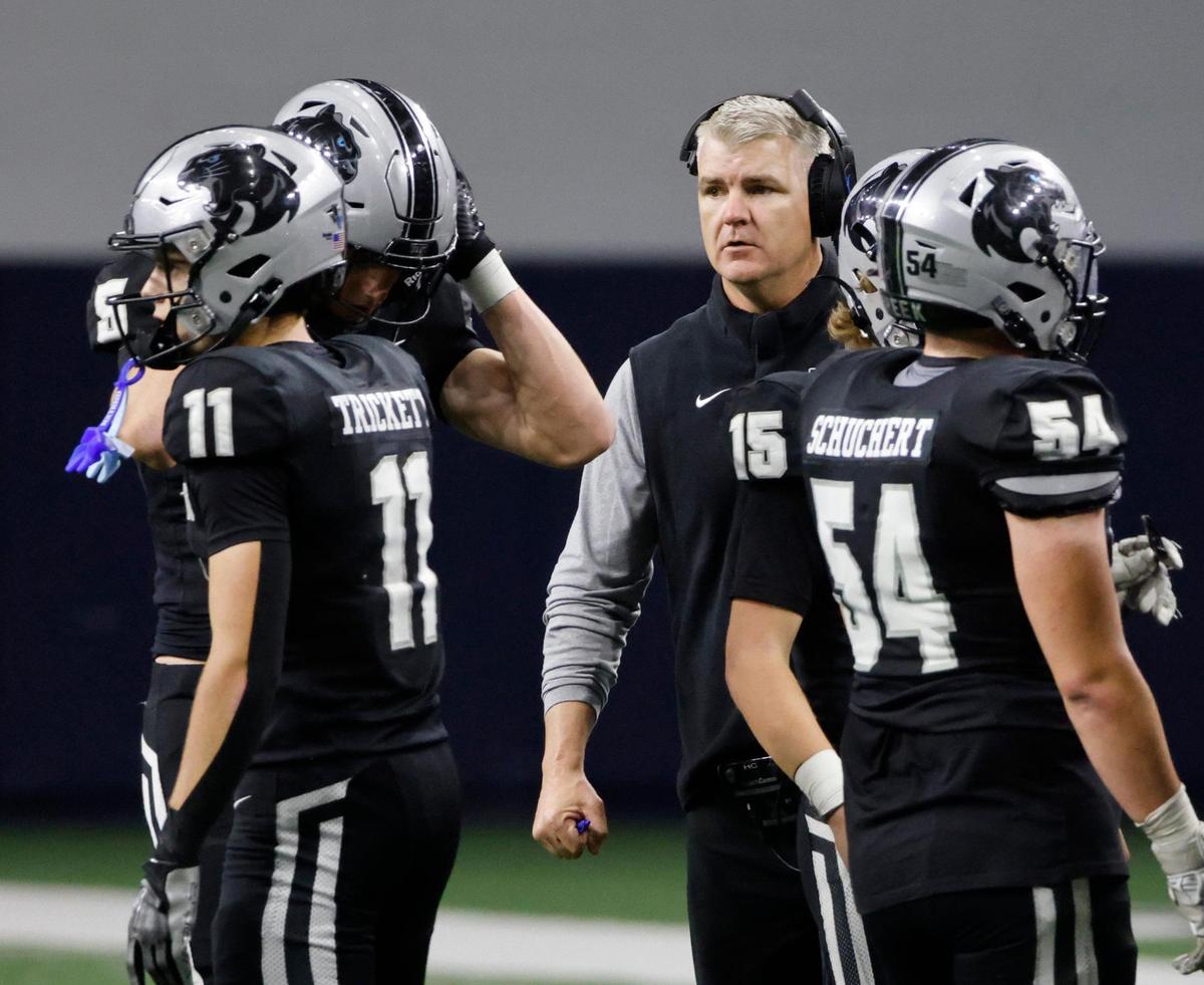 Panther Creek head coach Clint Surratt talks to the team during a timeout during a UIL 4A D1 Area round football playoff game at The Ford Center in Frisco Texas, Thursday, Nov. 21, 2024.