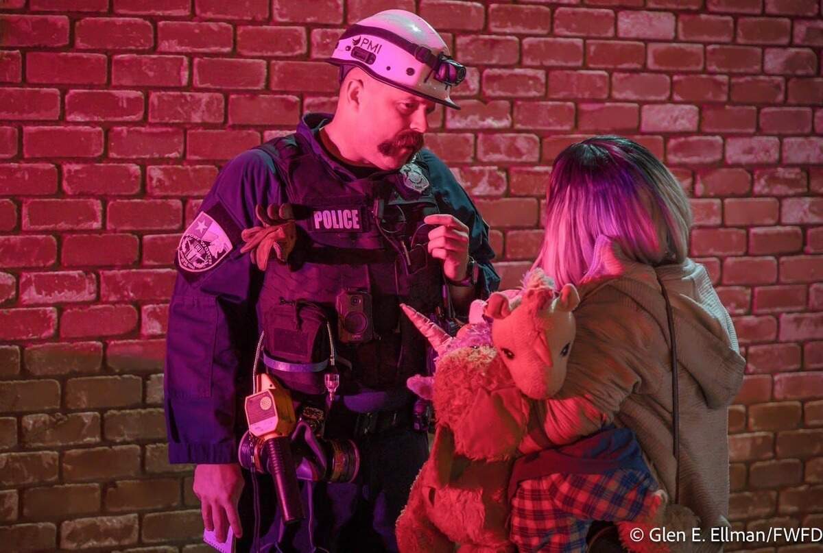 Fort Worth firefighters assist residents at the scene of an apartment fire at 3100 Hamilton Ave. on Friday, Feb. 28, 2025.