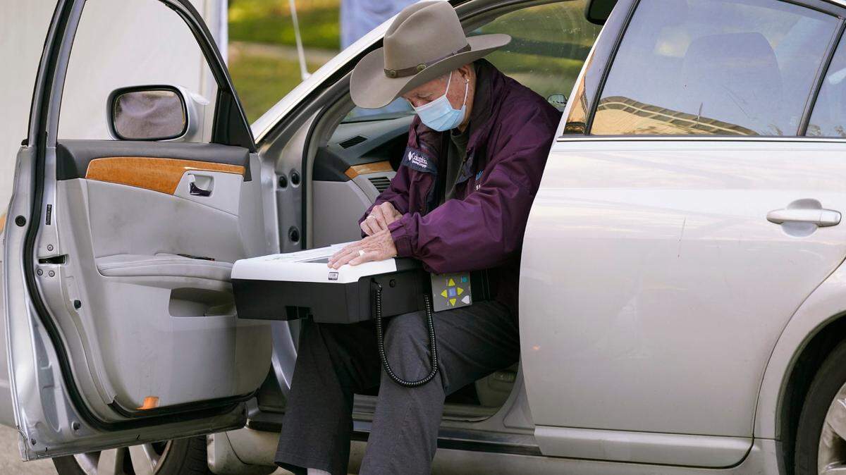 In this file photo, an elderly voter uses the drive-thru option to vote from his car outside Richardson City Hall on Oct. 13, 2020. On Tuesday, Texas released details on its audit process of the 2020 election for four counties, including Tarrant.