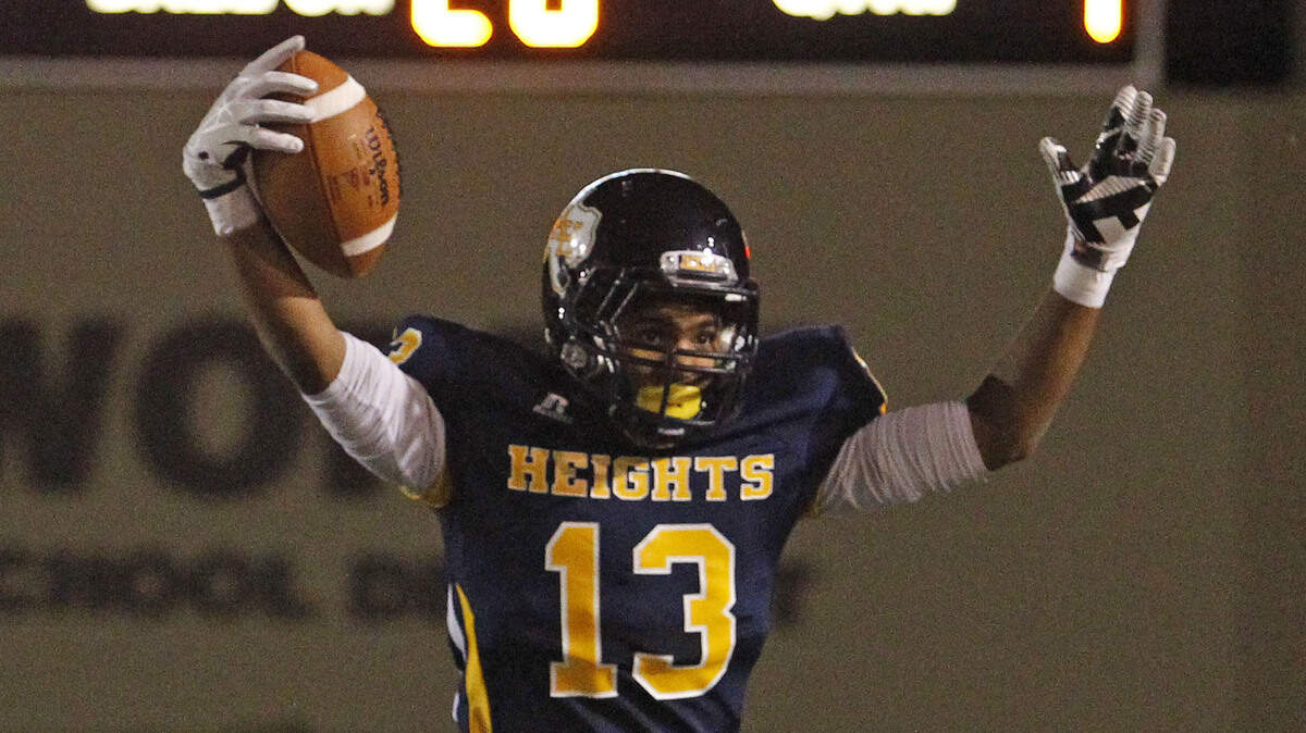 Former Arlington Heights football player Elijah Pierson celebrates a touchdown in 2013. He died in a crash early Sunday.