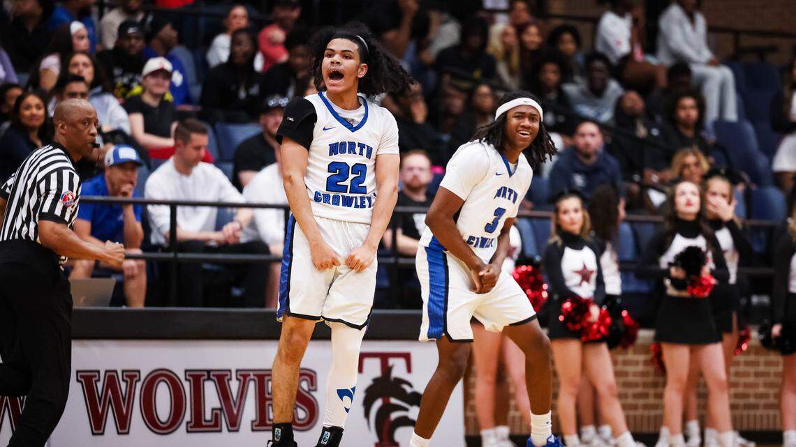 North Crowley guard Isaak Hayes (22) jumps in the air and screams in celebration alongside teammate Dontre Grandberry during a Class 6A Division I regional semifinal against Coppell on March 3 at Timberview High School.
