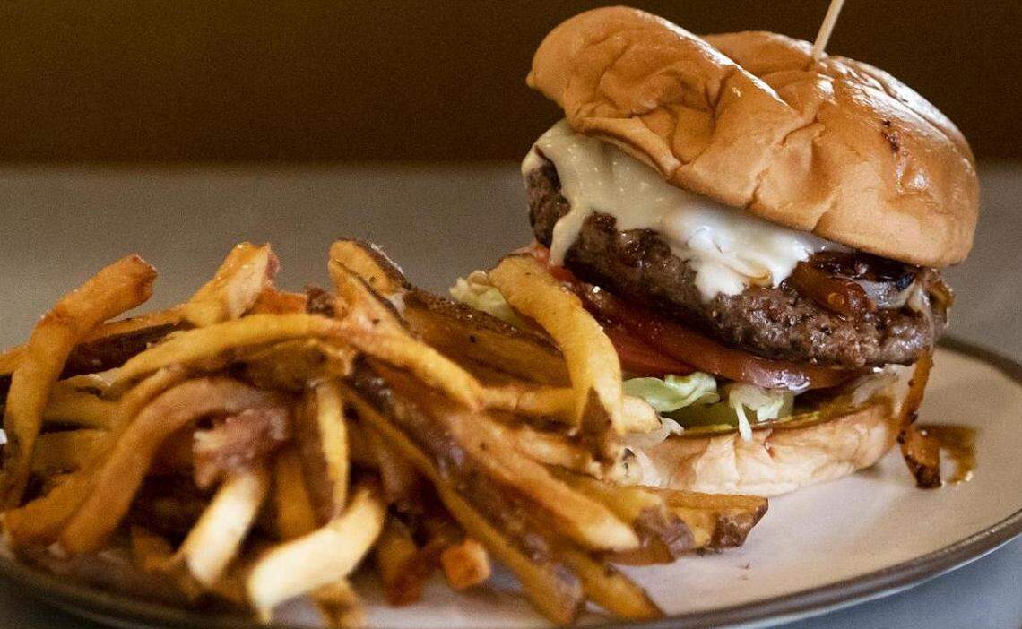 The Diablo burger at Fred’s Texas Cafe on Friday, June 17, 2022. The Diablo burger, one of Fred’s iconic menu items, features chipotle brown butter, grilled onions, Swiss cheese, pickles, lettuce, tomato and mustard.