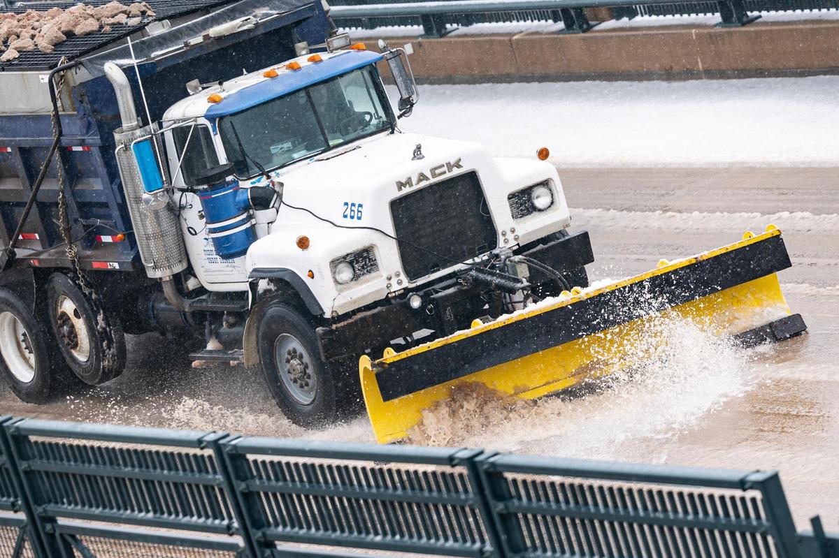 A snow plow truck shovels snow off to the sides of the road on the Chisholm Trail Tollway in Fort Worth on Thursday, Jan. 9, 2025.